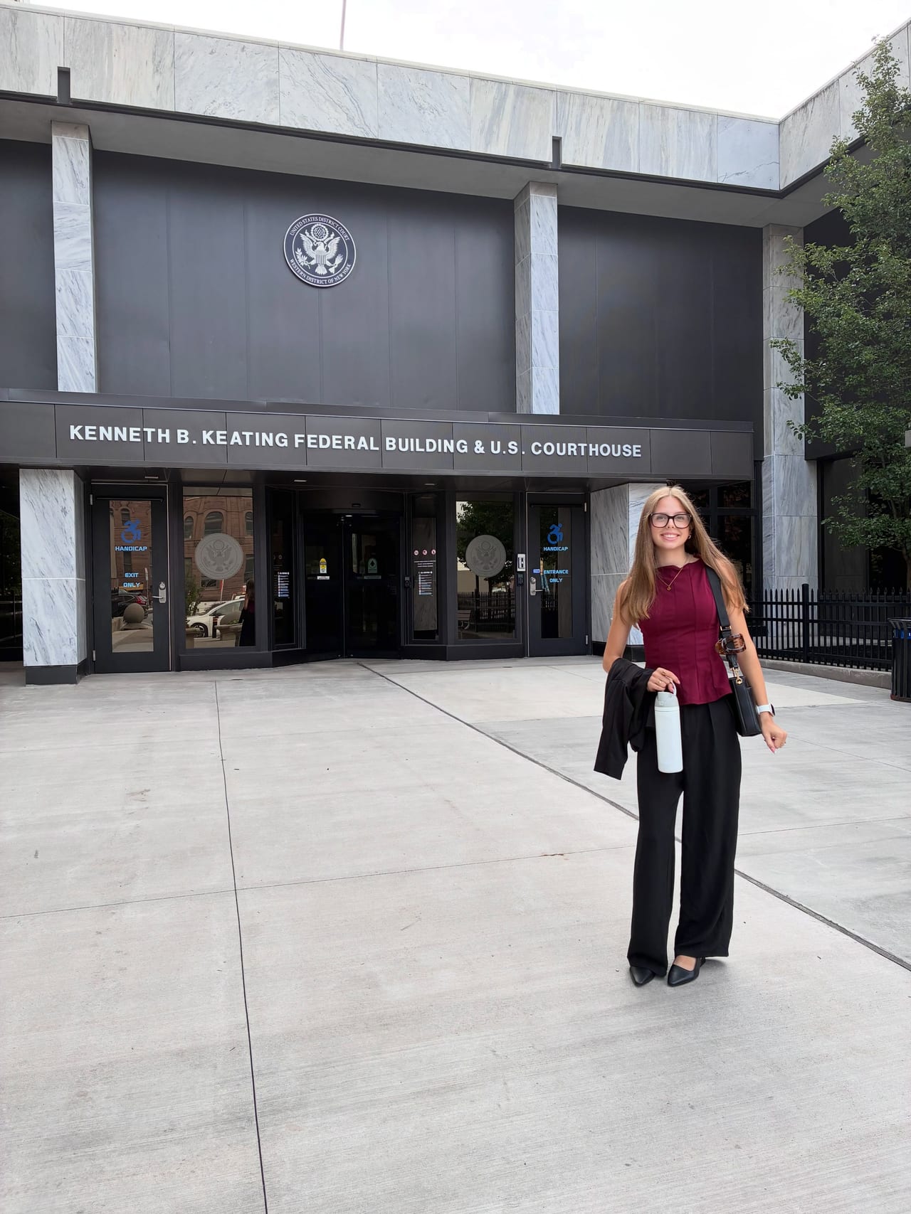 Abbi’s program photograph outside a federal courthouse