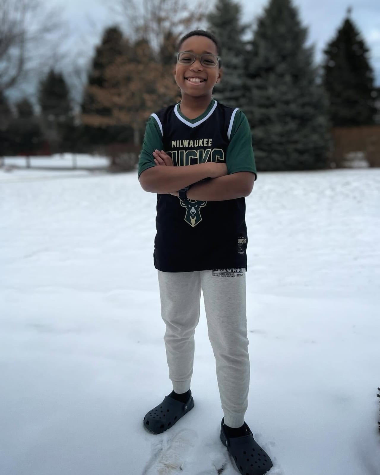 Aidan smiling outdoors in a Bucks jersey