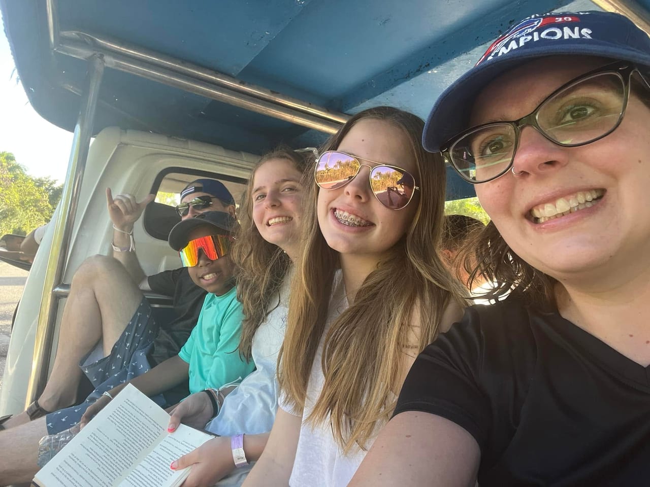 The family squeezed into an open shuttle, smiling for a selfie