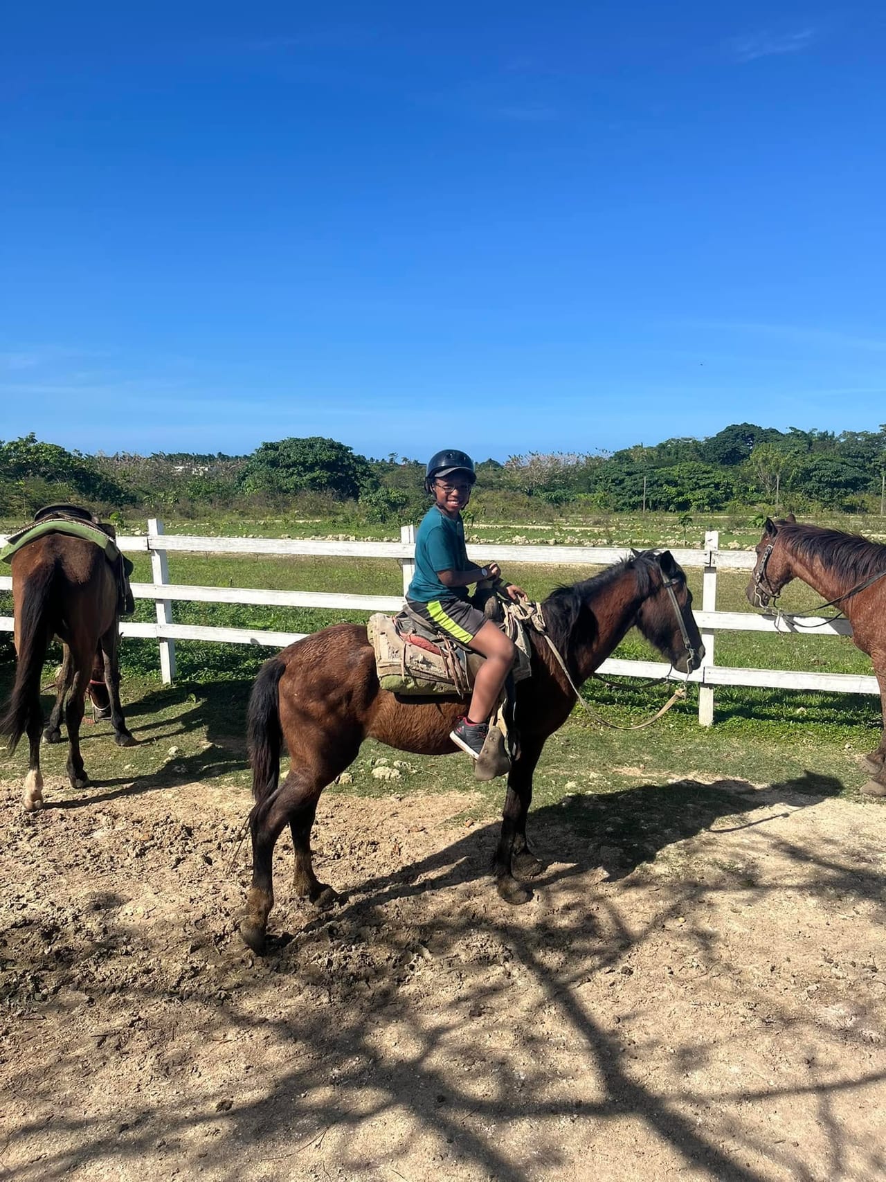 Aidan in a riding helmet on horseback