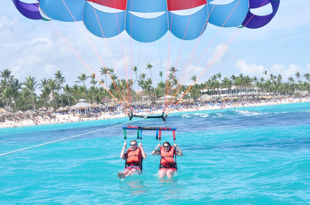 Parasailing high above turquoise water near the beach