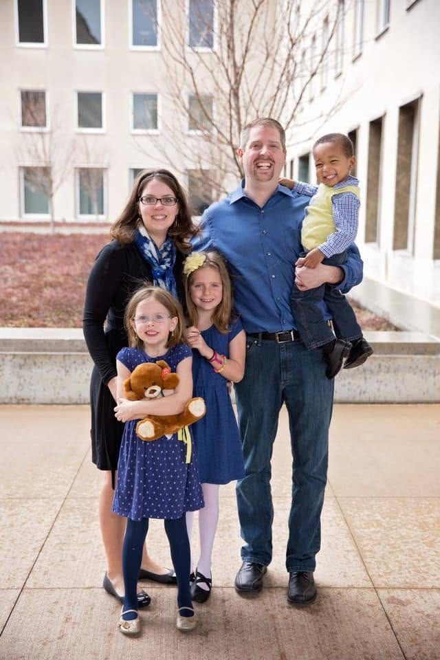 Dave, Cassie, Bella, Abbi, and Aidan outside the courthouse on Aidan’s adoption day, Dave holding Aidan